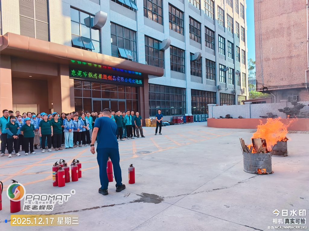 Firefighters conduct a live fire demonstration with extinguishers during factory fire safety training at the factory site.