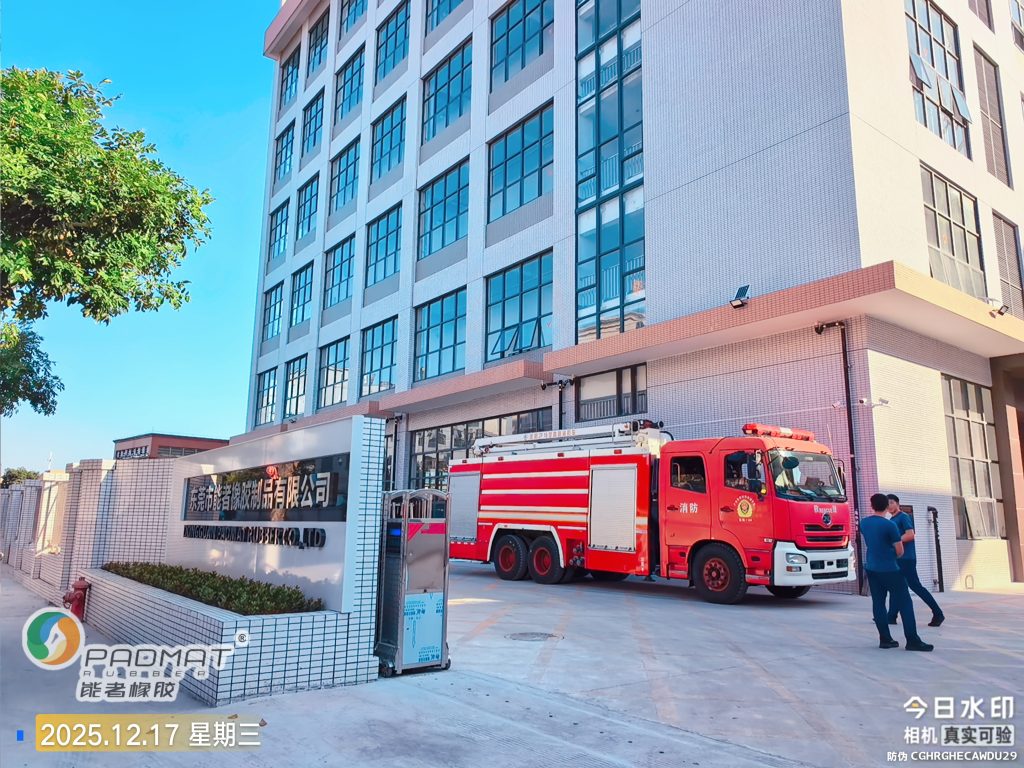 Fire truck parked outside the factory building during factory fire safety training and on-site fire drill.