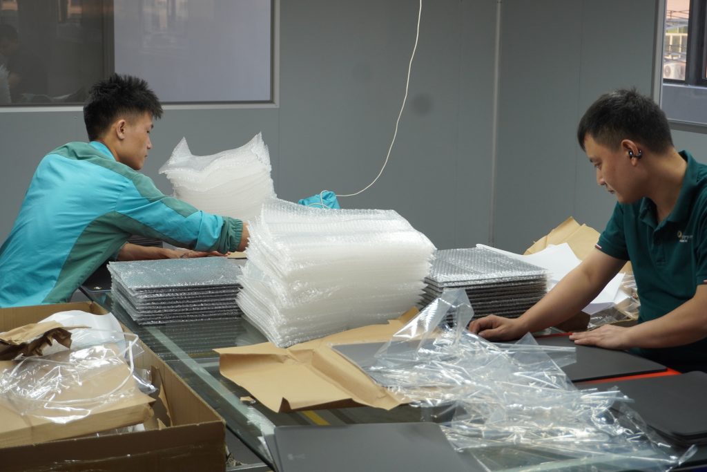 Workers packaging rubber mat products inside Padmat Rubber’s new facility, supporting the company’s operations as a rubber mat OEM supplier.