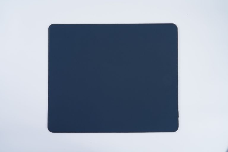 Cloth gaming mouse pad with woven surface and natural foam rubber base, produced by a professional gaming mouse pad manufacturer.