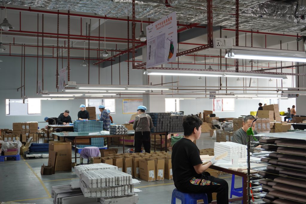 Workers packing finished mouse pads in professional mouse pad manufacturer’s packaging workshop.