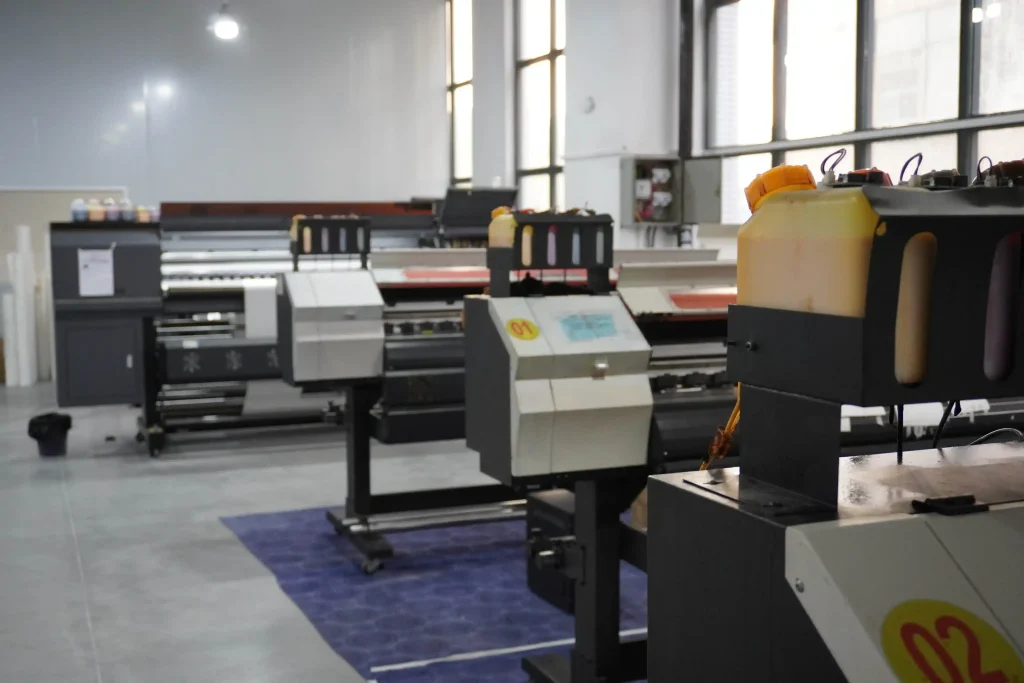 Digital printing machines for custom mouse pad production in factory workshop.